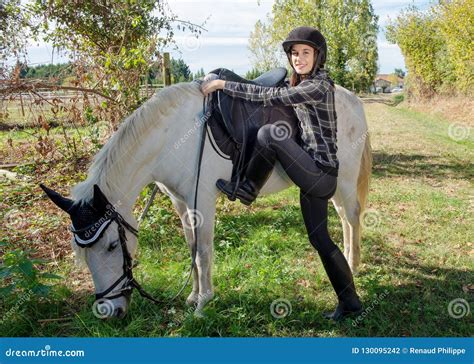Young Woman Rider Mounting A White Horse Stock Photo Image Of