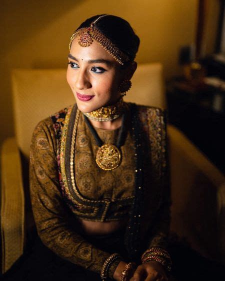 Photo Of Bride Twirling In Coral Lehenga With Gold Embroidery