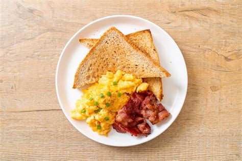 Premium Photo Scrambled Egg With Bread Toasted And Bacon For Breakfast