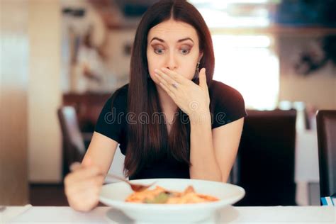 Woman Feeling Sick While Eating Bad Food In A Restaurant Stock Image