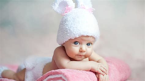Grey Eyes Cute Toddler Is Lying Down On White Pink Bath Towel Wearing