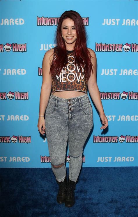 A Woman With Long Red Hair Wearing High Waist Jeans And Leopard Print