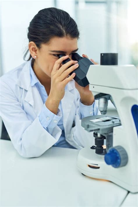 Lets See What We Have Herea Young Scientist Using A Microscope In A