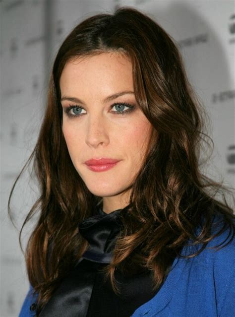 liv tyler with her choclocate colored long hair sectioned in the middle