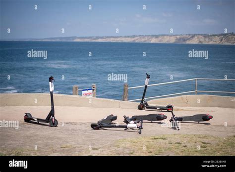 Four Abandoned Electric Scooters La Jolla Cove Overlooking Ocean Stock