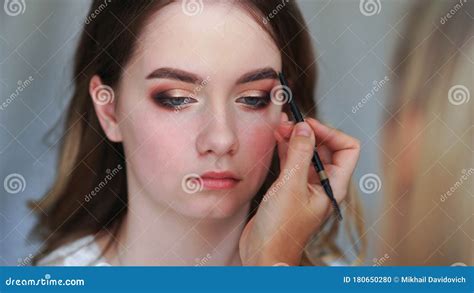 Makeup Artist Paints Eyebrows Of A Young Girl Stock Photo Image Of