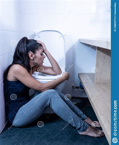 Attractive Young Woman Sitting In The Bathroom Feeling Sick And Looking Depressed And Guilty