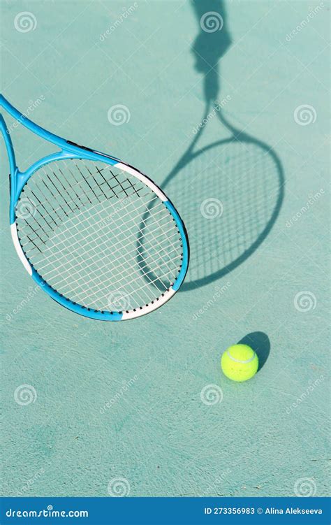 Tennis Ball And Racket On Blue Hard Tennis Court Shadow Of A Hand Holding Tennis Racket On The