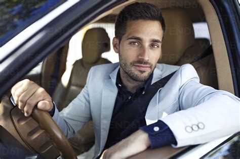 Successful Young Businessman Driving In His Car Stock Photo