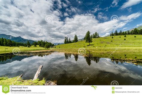Beautiful Mountain Lake And Reflection Of Surroundings In