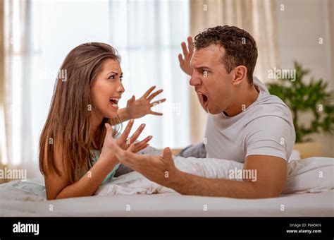 Angry Couple Is Having An Argument In Bed They Are Shouting At Each