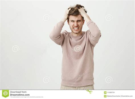 Portrait Of Very Angry Caucasian Man Pulling Out His Hair Being Mad