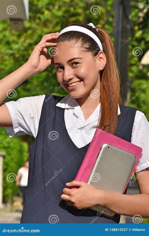 Young Teenage Girl Wearing School Uniformsitting On A
