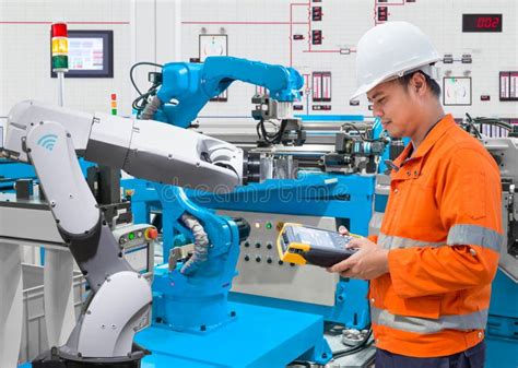 Maintenance Engineer Programing Automated Robotic At Industry 4 Stock