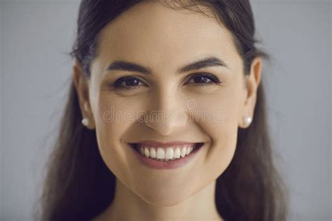 Head Shot Of Happy Young Woman With Long Dark Hair And Friendly Open