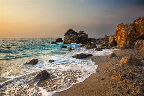 Sunset On Rocky Beach And Waves Greece Photograph By Sandra Rugina Pixels