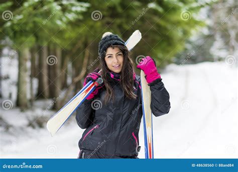 Portrait Of Beautiful Woman With Ski And Ski Suit In Winter Mountain