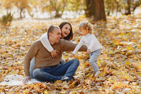 Happy family having fun in autumn park · Free Stock Photo
