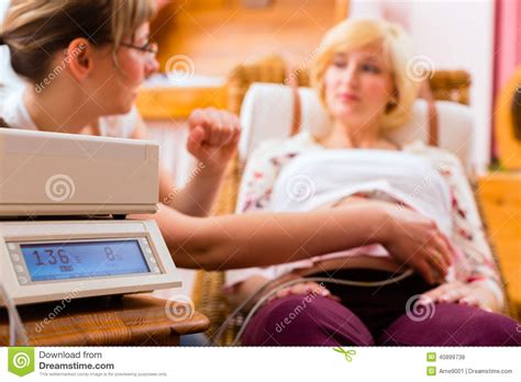 Midwife Seeing Mother For Pregnancy Examination Royalty Free Stock