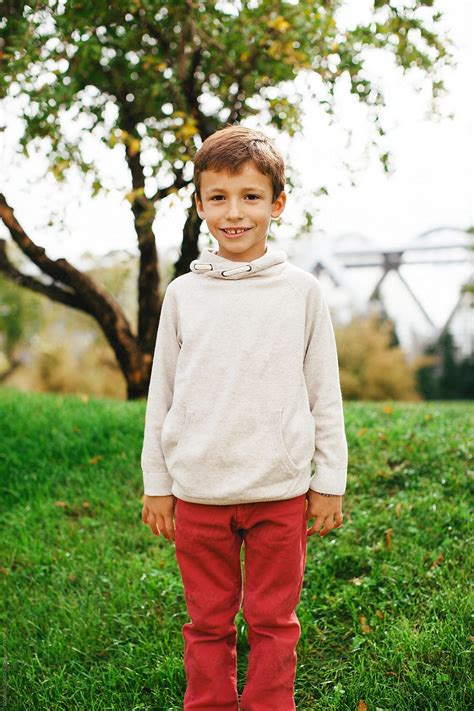 Portrait Of An Adorable Little Boy Standing In The Park By Stocksy