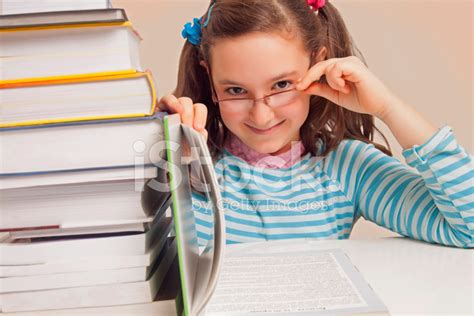 Girl With Glasses Reading A Book Stock Photos