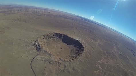An Aerial View Of A Crater In The Desert