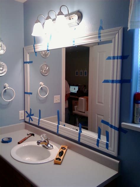 This diy mirror frame is an easy and budget friendly bathroom update. This Thrifty House: Framed Bathroom Mirror