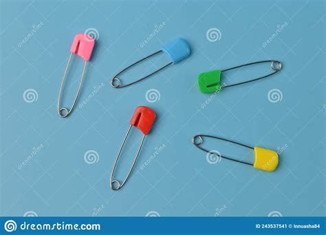 Colorful Safety Pins Isolated On A Blue Background Stock Image Image