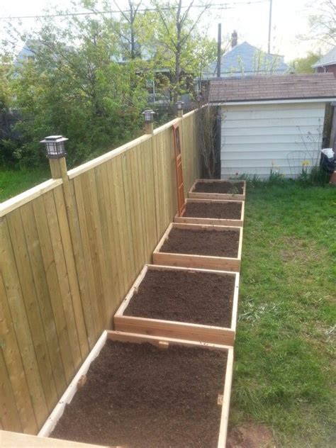 This unit even has a wire fence for extra insurance. Raised beds along fence (4x4 ceader beds) | Backyard ...