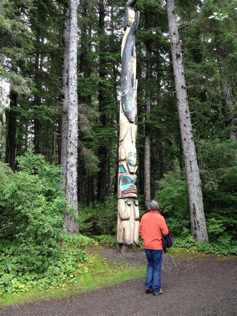Visitors Enjoy Totem Carvings At Sitka State Historical Park In Alaska
