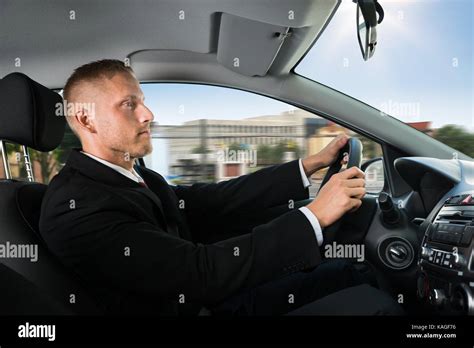 Photo Of Confident Young Businessman Driving His Car Stock Photo Alamy