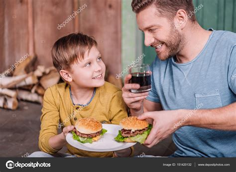 Father And Son With Homemade Burgers — Stock Photo © Alexlipa 151420132