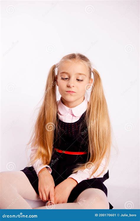 schoolgirl sitting cross legged on a white background stock image image of people single