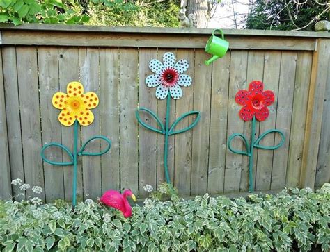 Maybe you would like to learn more about one of these? Dollar store flowers turned into garden art with hoses for ...