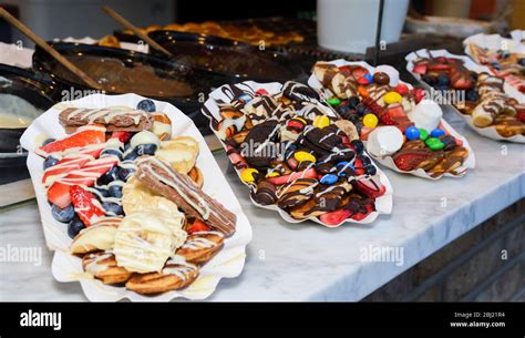 Street Food Dessert Waffles And Small Pancakes With Varied Toppings