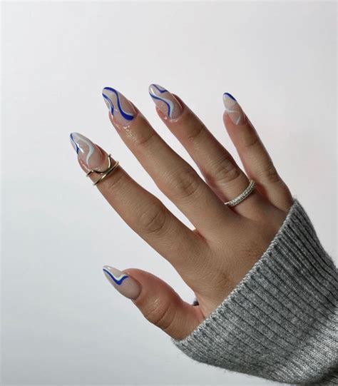 40 Trendy Summer Almond Nail Designs — Blue Swirl Shimmery Sheer Nails
