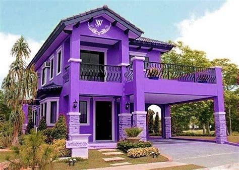 A Purple House With An Attached Balcony And Balconies On The Second