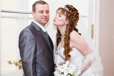 Young Wedding Caucasian Russian Couple Bride Kissing Groom In Cheek