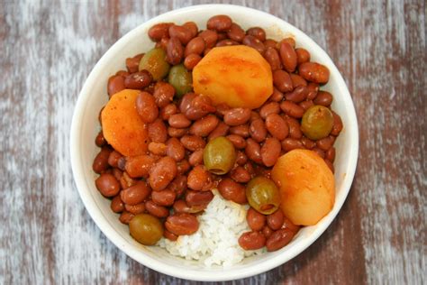 Flavorful puerto rican rice and beans simmered in a sauce of sofrito and tomato along with potatoes and olives. Puerto Rican Rice and Beans (Habichuelas Guisadas) | Kitchen Gidget