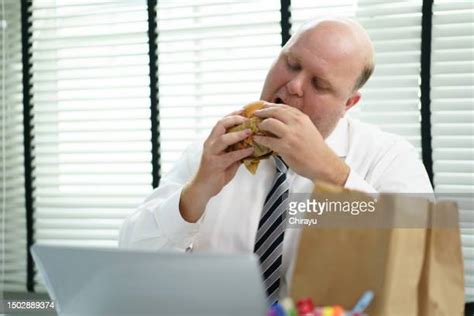 Fat Guy Eating Cheeseburger Photos And Premium High Res Pictures