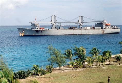 A Large Ship In The Water Near Some Palm Trees