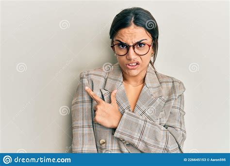 Young Brunette Woman Wearing Business Jacket And Glasses Pointing Aside
