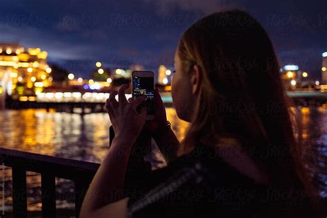 Girl Taking A Photo Of Singapore S Merlion And Skyline At Night By Stocksy Contributor Angela