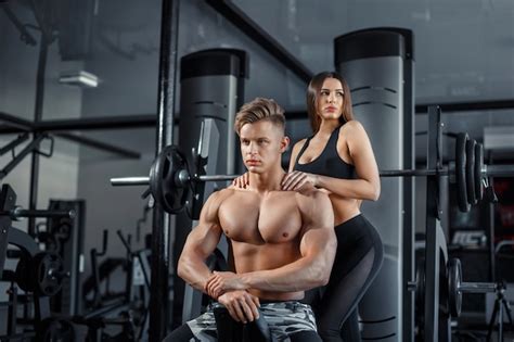 Premium Photo Beautiful Young Sporty Sexy Couple Showing Muscle And Workout In Gym During