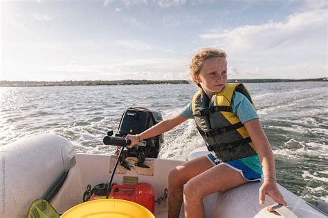 Child Driving Boat For The First Time By Stocksy Contributor Raymond