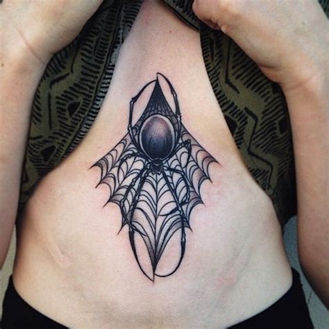 A Woman With A Spider Web Tattoo On Her Chest