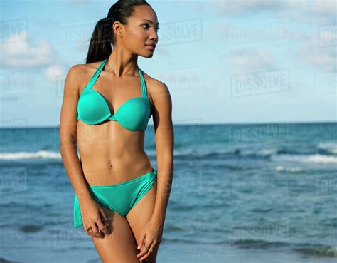 Hispanic Woman Wearing Bikini On Beach Stock Photo Dissolve