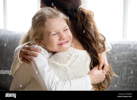 Cute Little Daughter Hugging Mother Holding Tight Mum And Happy