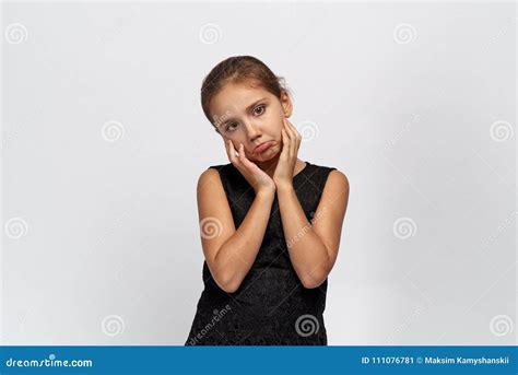 Unhappy Girl Looks Into The Camera Sticks Out Lip In Resentment Holding Her Hands Up Stock