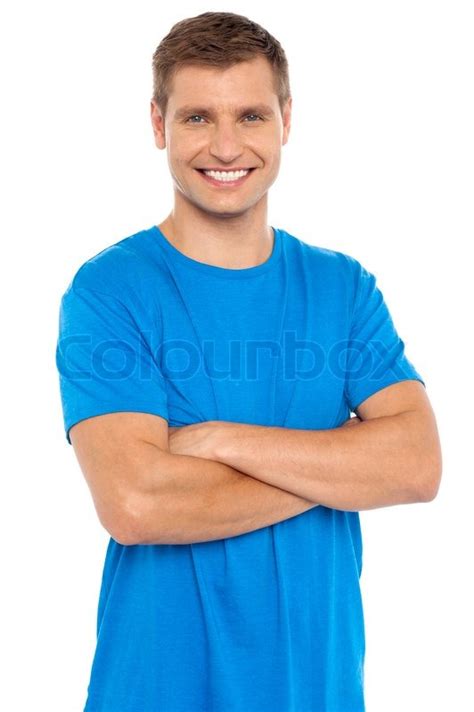 Casual Portrait Of Smiling Man Posing With Arms Crossed Stock Photo